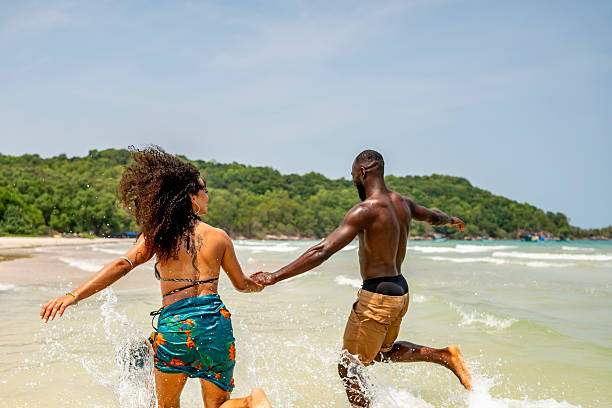 istock Happy Couple Running on Tropical Beach Vacation 2207944270