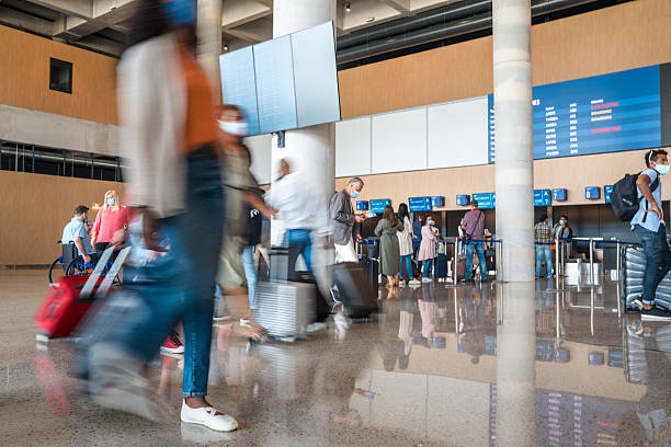 istock Diverse Group Of Unrecognizable People Moving Around The Airport 2207945686