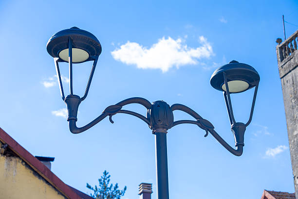 istock Vintage street lamp against a bright blue sky 2207945905
