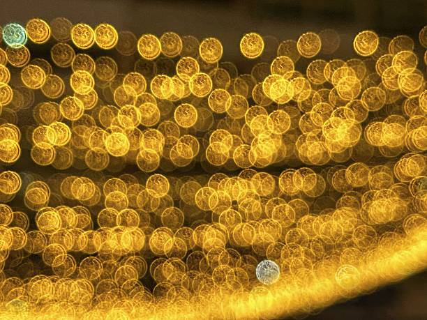 istock blurred bokeh light by night with yellow string lights decor in the street 2207946793