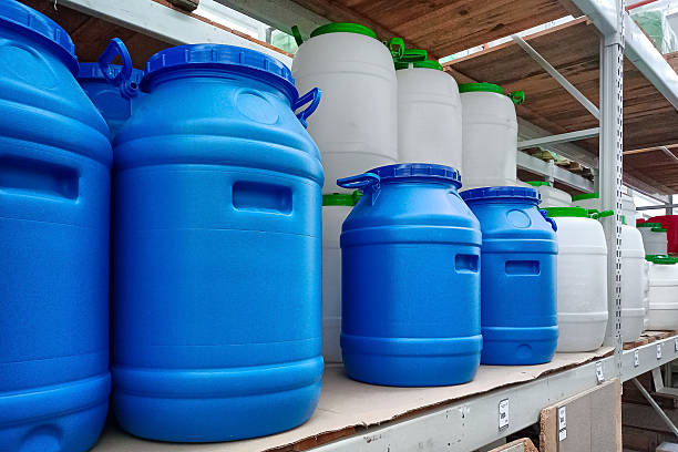 istock Large Blue and White Plastic Barrels on Storage Shelves 2207947911