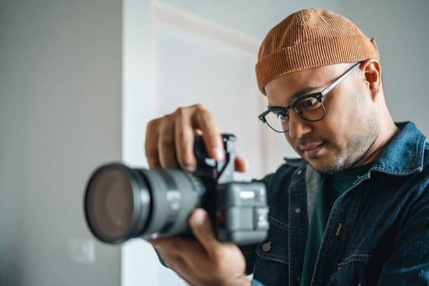 istock Professional man photographer working shooting woman model using digital camera and flash studio in studio on white background. photography concept. 2207949286