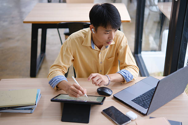 istock Student studying online and preparing for exams with digital devices and books 2207951817
