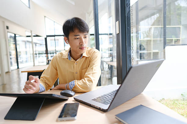 istock Student studying online and preparing for exams with digital devices and books 2207951853