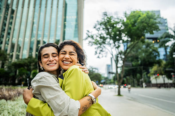 istock Friends embracing in the street 2207952164