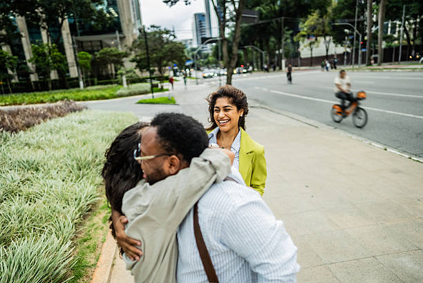 istock Friends greeting in the street 2207952189