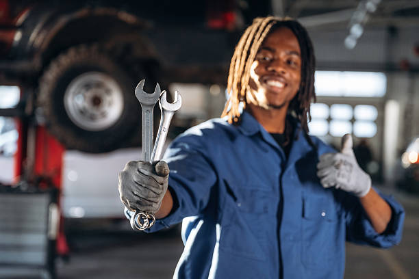 istock Tools in hands. Male mechanic is with car in garage 2207953342
