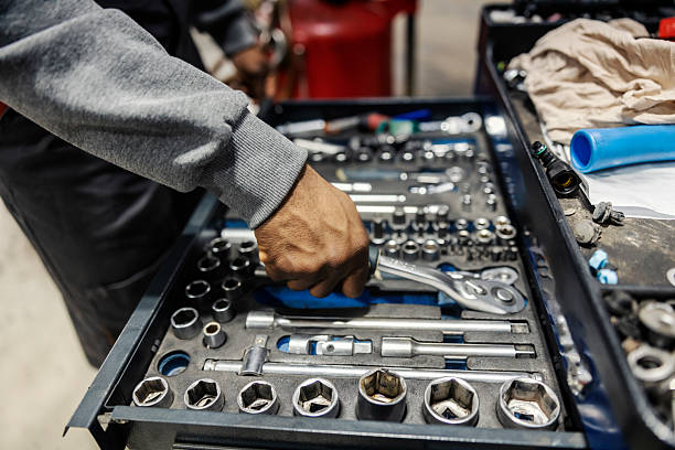 istock Close up of multicultural mechanic's hand taking wrench from toolbox at auto mechanic workshop. 2207955256