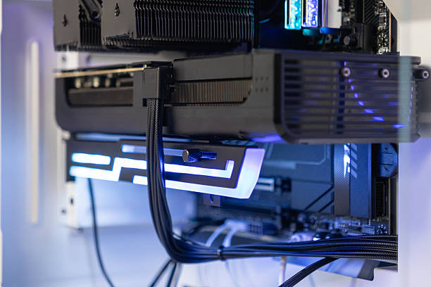 istock Close-up of GeForce RTX graphics card supported by illuminated RGB bracket inside modern custom-built gaming PC case 2207956339