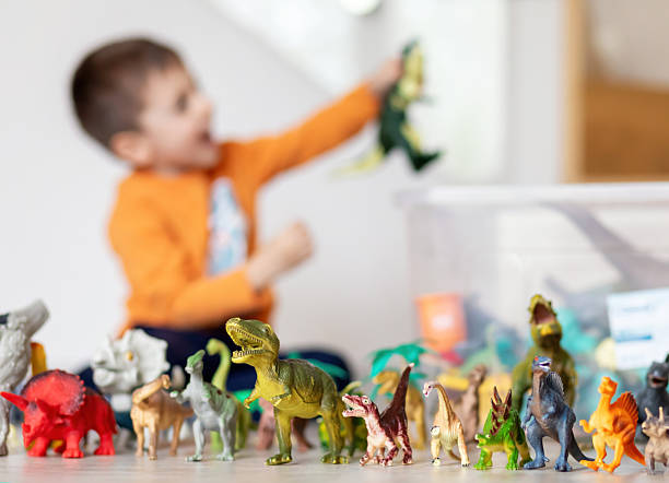 istock Child playing with dinosaur toys, imagination and learning concept 2207961083