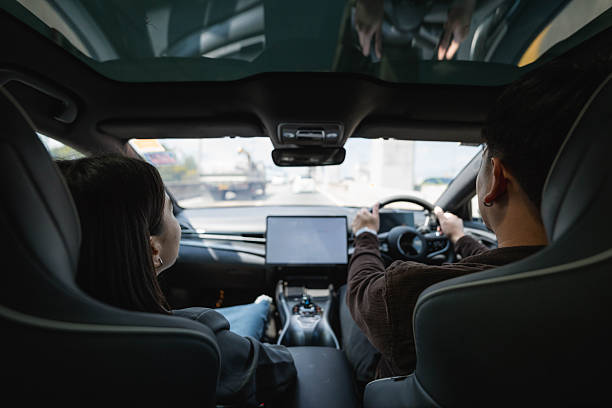 istock Man picking up his colleague in his EV car on the way to work 2207961191