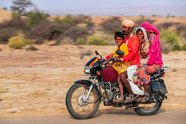 Manesar, Haryana, India -September 07, 2019 : Factory workers on bicycle and bike of different age group going for work.