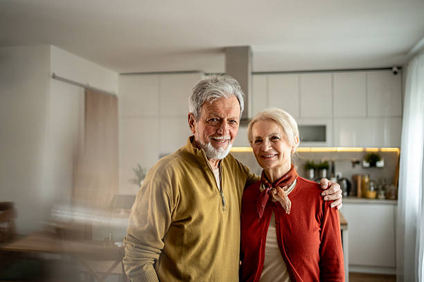 istock Happy senior couple embracing in their modern kitchen 2207961854