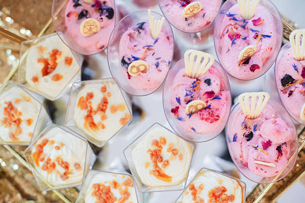 Bite-sized fruit, vanilla, and chocolate desserts served on a sweet table at a wedding. A tempting, high-calorie indulgence perfect for satisfying your sweet tooth.