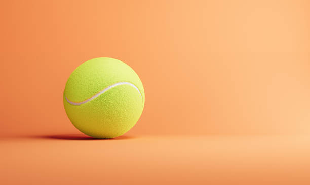 istock Green Tennis Ball On Orange Background 2207964405