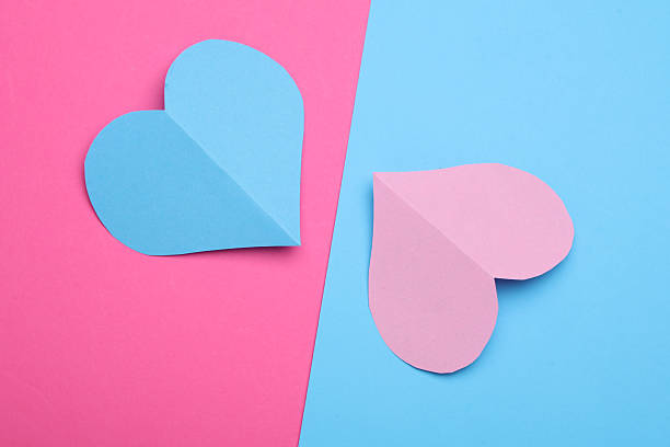 istock Paper hearts on a blue and pink background 2207965112