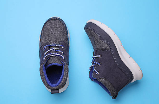 istock Children's warm sneakers half-boots on a blue background 2207965217