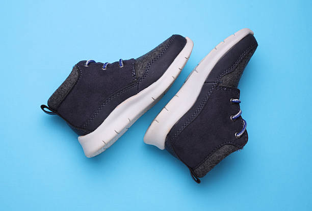 istock Children's warm sneakers half-boots on a blue background 2207965220
