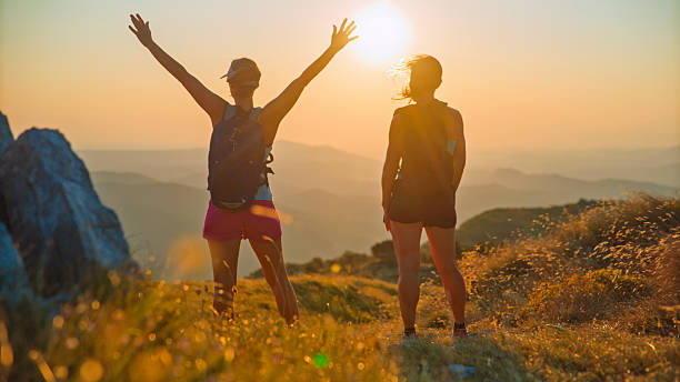 istock Two women Celebrate Running Success on Mountain Summit at Sunset 2207965234