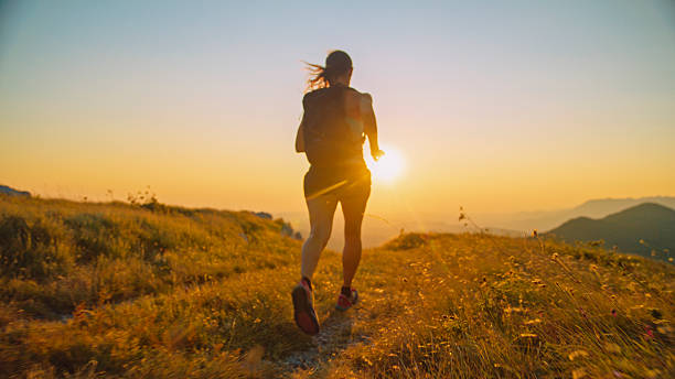 istock Woman Trail Running Alone Towards Sunset in the Mountains 2207965237