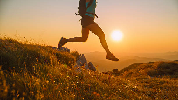 istock Woman Trail Runner Jumping on Mountain at Sunset 2207965242