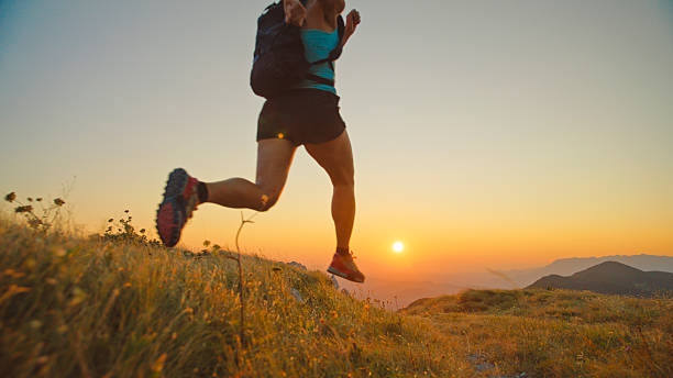 istock Woman Trail Runner Jumping on Mountain at Sunset 2207965261