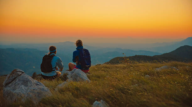 istock Women Adventurers Pause on Mountain Ridge at Sunset 2207965267