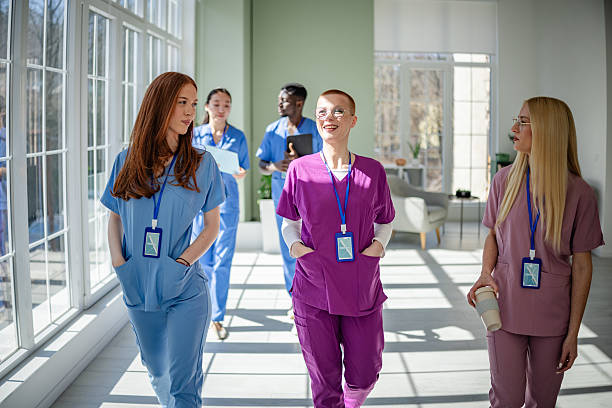 istock Young healthcare professionals engage in teamwork and discussion while walking through a modern medical clinic 2207965954