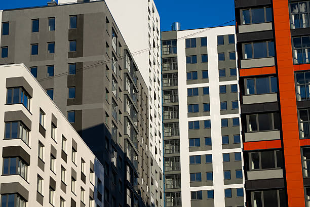 istock Modern residential buildings standing tall against blue sky 2207966345