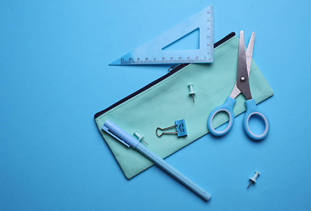 istock Pencil case with stationery on blue background. Flat lay. Top view 2207966380