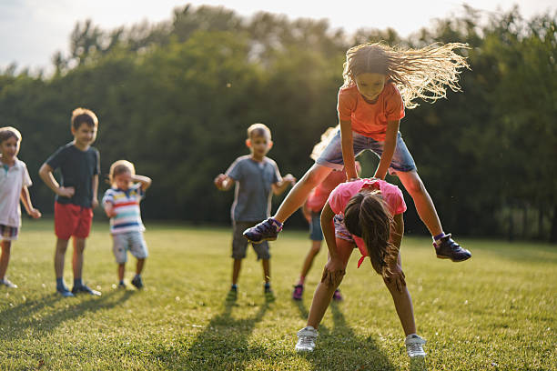 istock Children playing leapfrog game outdoors 2207966614