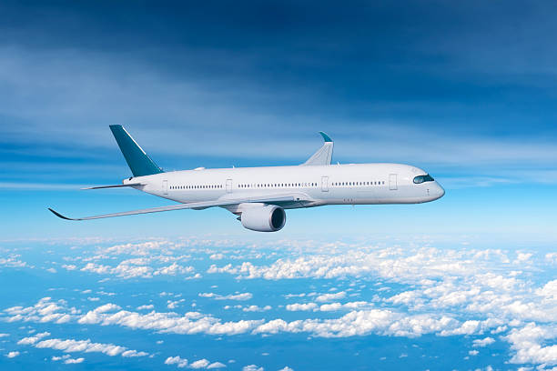 istock Jet airplane in the sky above the white clouds flight journey sun height 2207967857