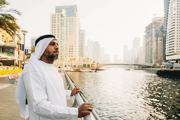 istock Emirati businessman looking at Dubai Marina skyline 2207968722