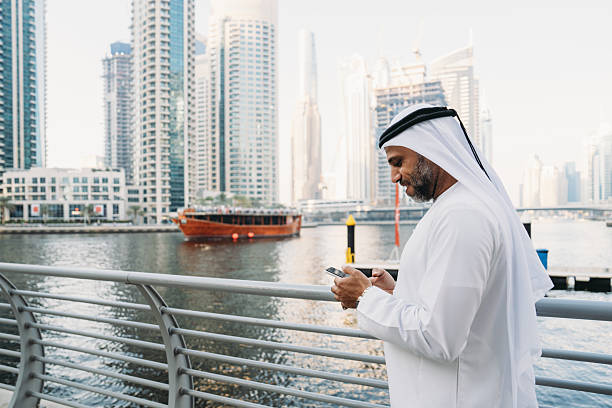 istock Emirati businessman using smartphone in Dubai Marina 2207968741