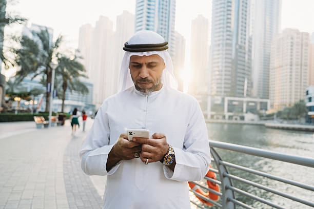 istock Emirati businessman using smartphone in Dubai Marina 2207968756