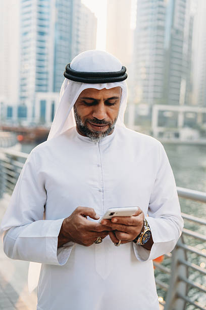 istock Emirati businessman using smartphone in Dubai Marina 2207968763