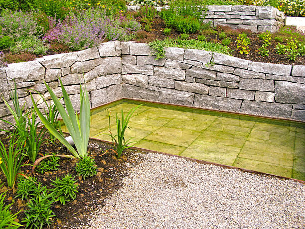 istock Gardendesign with stone wall and water garden 2207970010