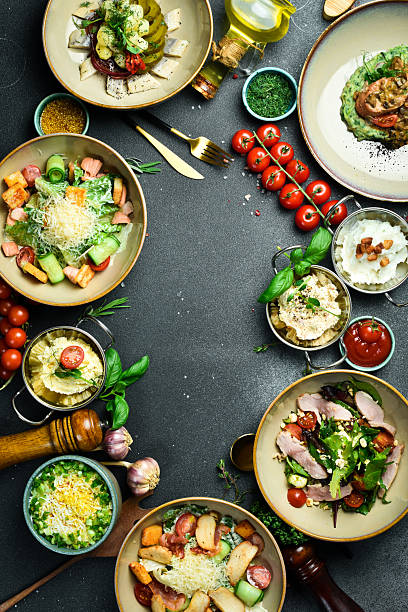 istock Food. Set of dishes and spices on the table, table setting, dining table. On a dark stone background. free space for text. 2207974670