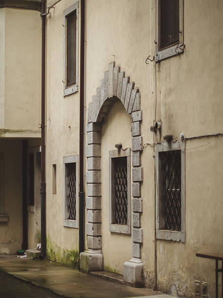 istock Historic stone doorway on aged building facade 2207974862