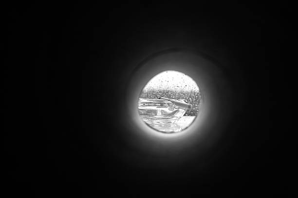 istock View of a cigarette in an ashtray from a dark hole 2207976548