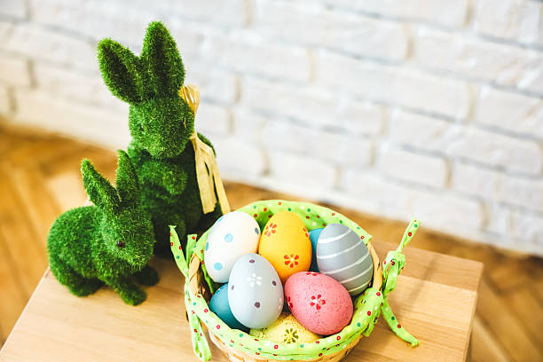 istock Colorful Easter eggs and decorative bunnies on table in spring celebration setup 2207978939