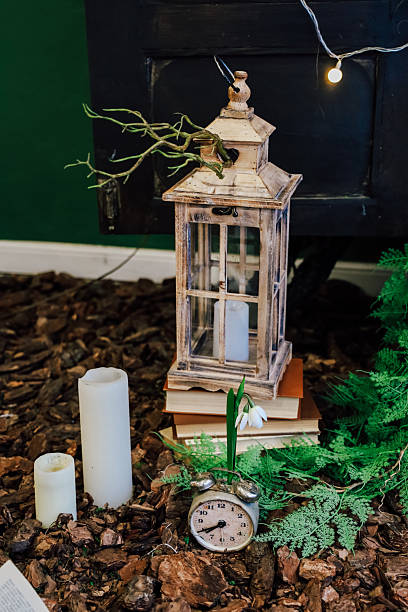 Decorative lantern and vintage clock create a cozy ambiance in a natural setting
