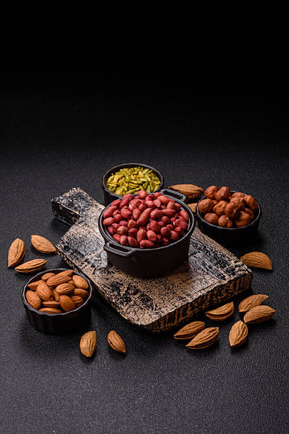 istock Peanuts or peeled graundnut in a bowl on a dark concrete background 2207979725