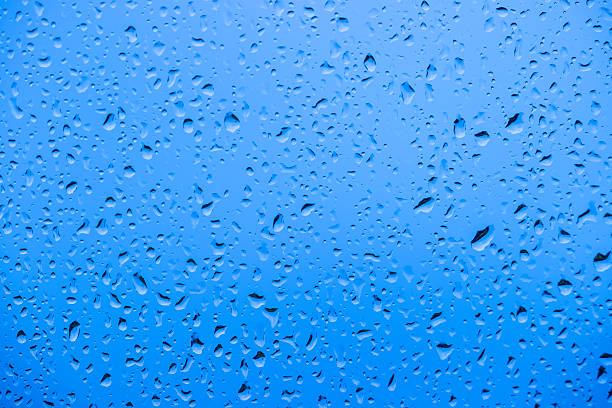 istock Raindrops on glass against a vibrant background 2207980100