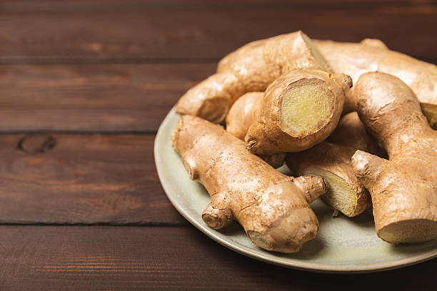 istock Fresh ginger on wooden background. Dry ginger. Sliced ​​ginger with honey and lemon. Ginger root. Traditional alternative medicine, healing tea for immunity. Seasoning and spices concept. Copy space. 2207981048