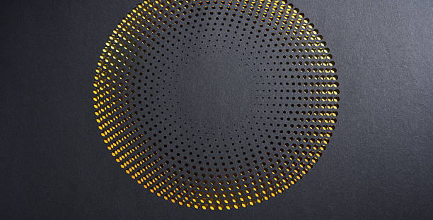 istock Circular halftone paper cut artwork with black surface revealing vibrant yellow gradient in a modern abstract pattern 2207981335