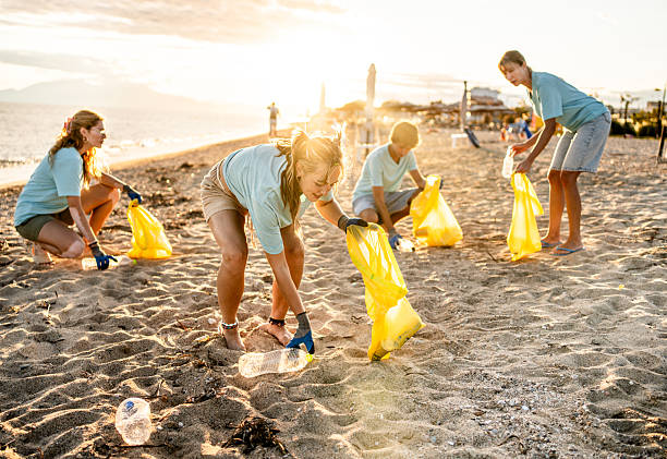 istock Group of people cleaning beach area 2207983332