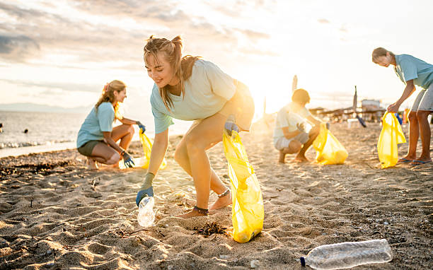 istock Group of people cleaning beach area 2207983405