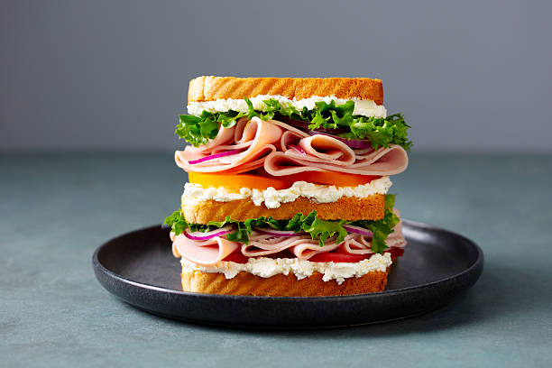 istock Club sandwich on a black plate. Grey background. Close up. 2207983411