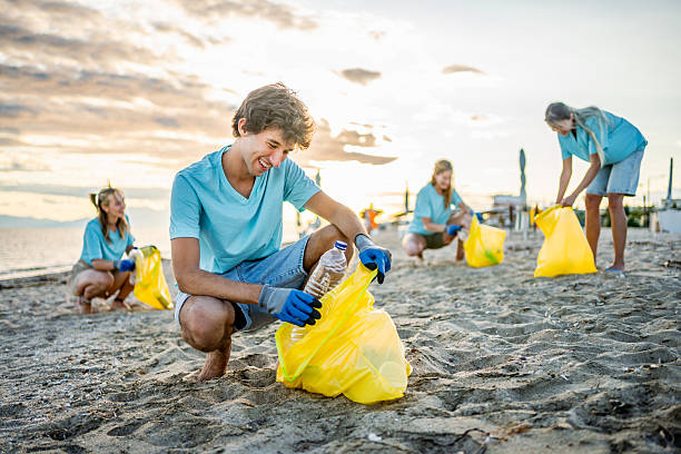 istock Volunteer cleaning a polluted beach 2207983627